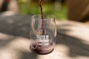 Red wine pouring into a Taste of Sonoma glass